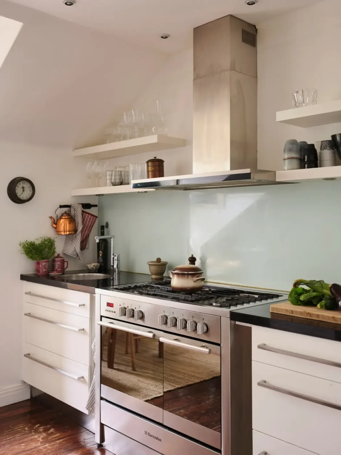 Exposed Beams and Dark-Stained Floorboards in a Cozy Attic Apartment 13 white kitchen with shelves