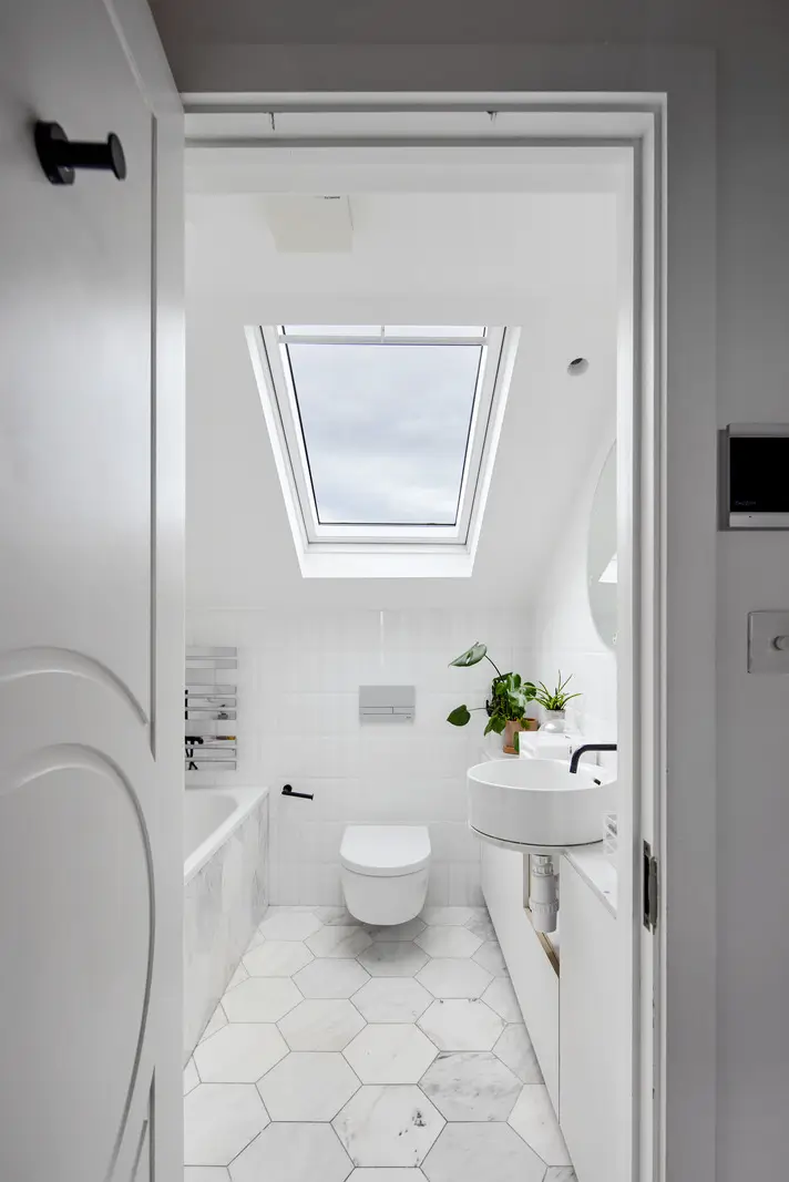 Victorian Grandeur Meets Modern Design in a Camden Square Townhouse 23 white marble attic bathroom
