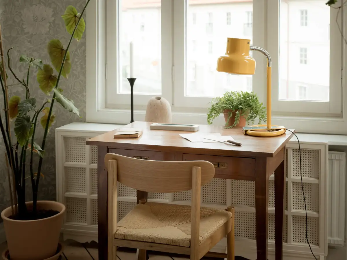 A Cozy Apartment with Exposed Brick and Period Details 11 wooden desk yellow table lamp