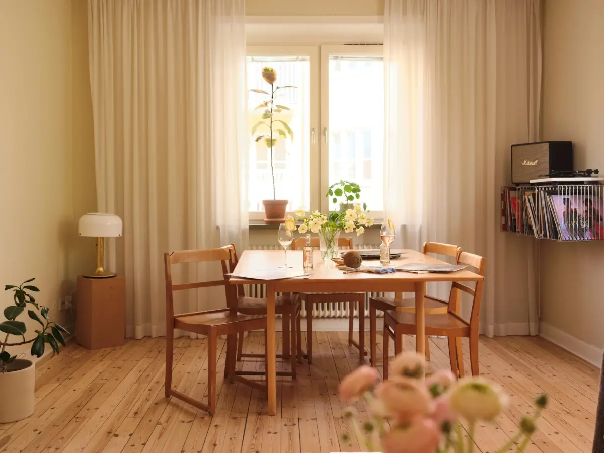 Soft Beige Interiors with the Occasional Bright Color Pop in Stockholm 3 wooden dining table beige living room