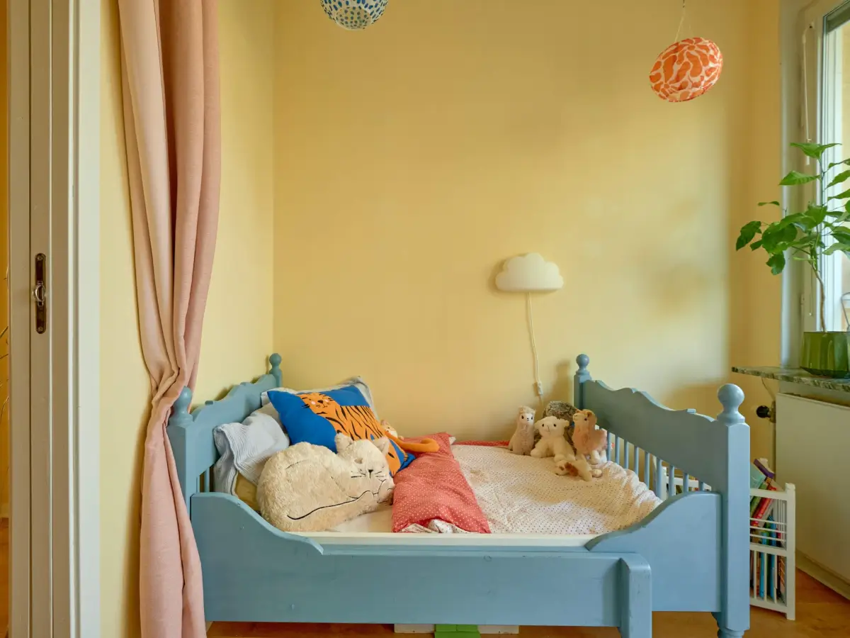 A Colorful and Cozy Midcentury Apartment in Stockholm 22 yellow kids bedroom blue bed