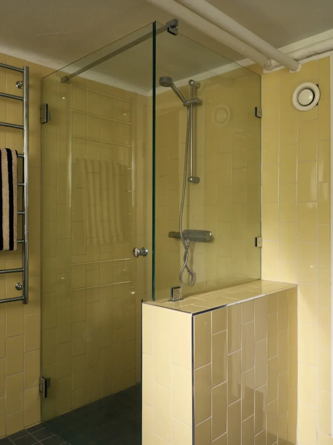 A Cheerful Color Palette in an Early 20th Century Villa in Stockholm 31 yellow tiled shower