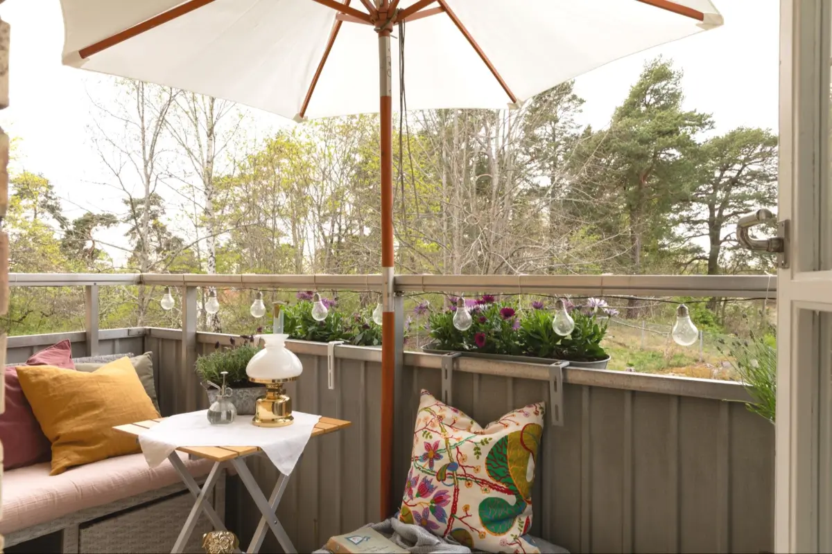 A Well-Preserved 1950s Apartment North of Stockholm 7 balcony with bench and string lights
