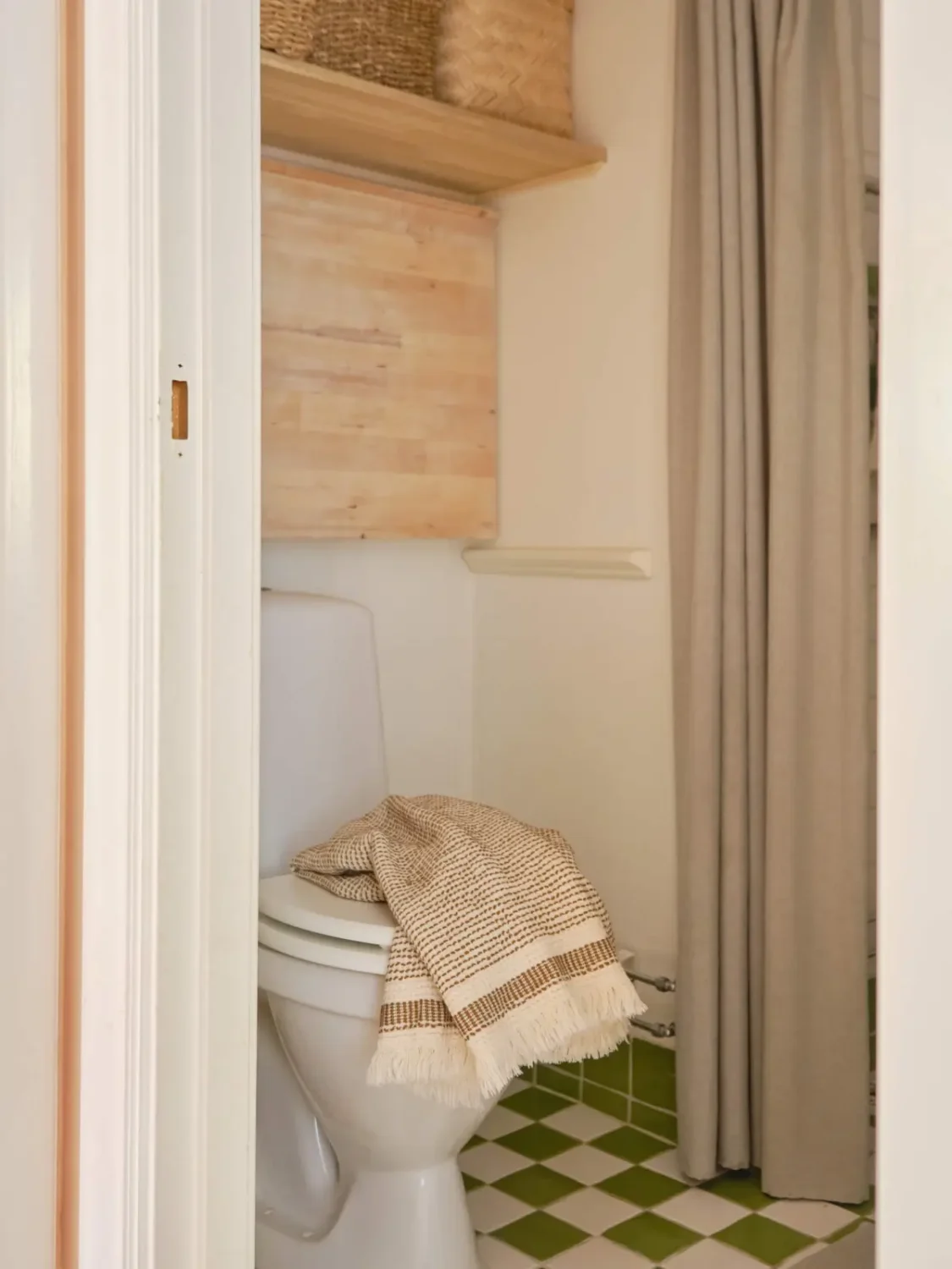 Green and Apricot Rooms in a Charming Stockholm Apartment 25 bathroom green and white floor tiles