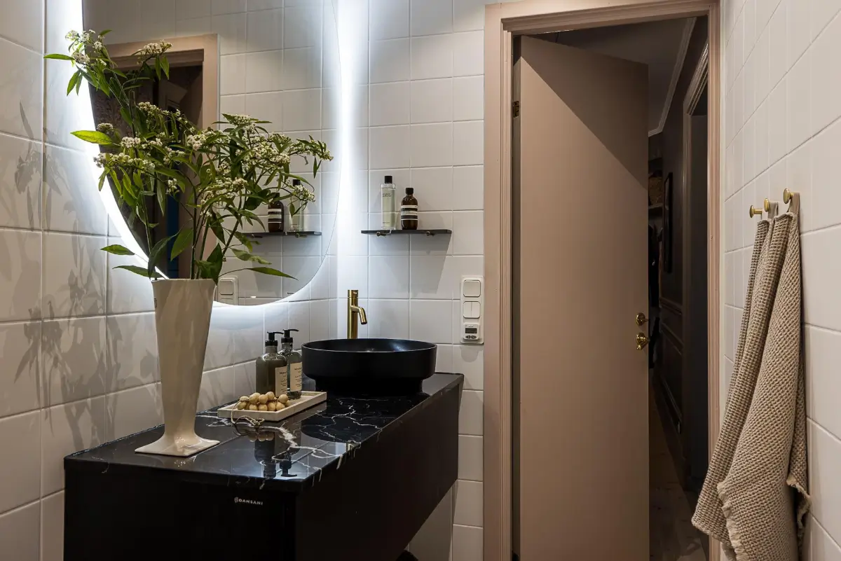 Gray Tones, Wallpapers, and a Mint Green Fireplace in a Swedish Apartment 32 bathroom marble vanity top black sink