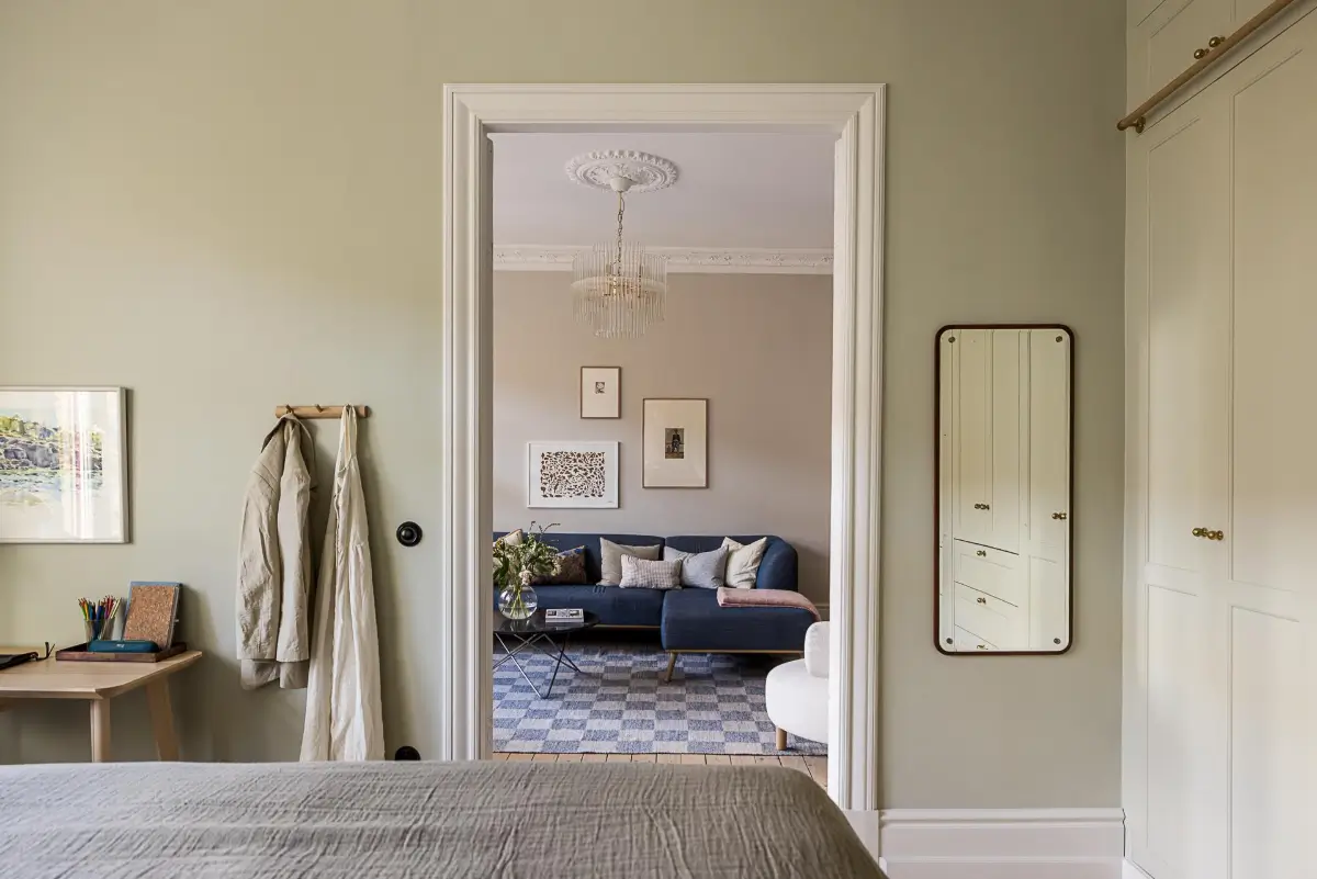 A Classic Renovated Apartment with a Social Light Green Kitchen 15 bedroom view into living room