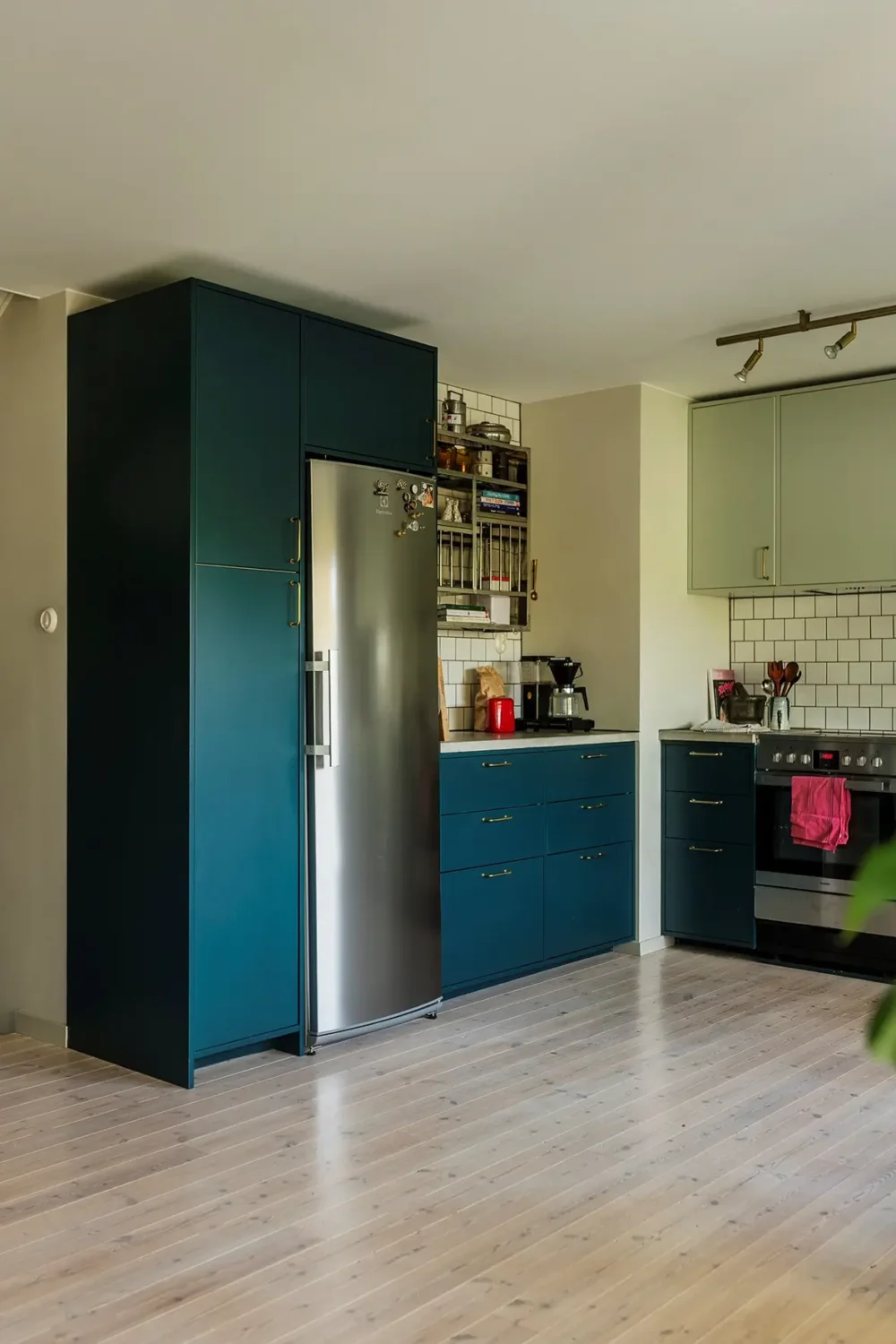 A Charming 1960s Family Home in Stockholm 7 blue and green kitchen
