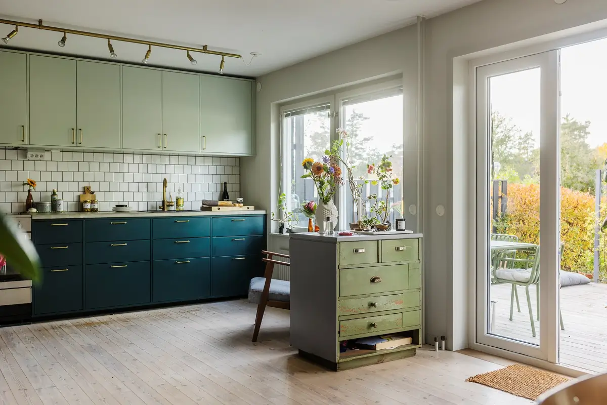 A Charming 1960s Family Home in Stockholm 5 blue and green kitchen brass fittings white tiles