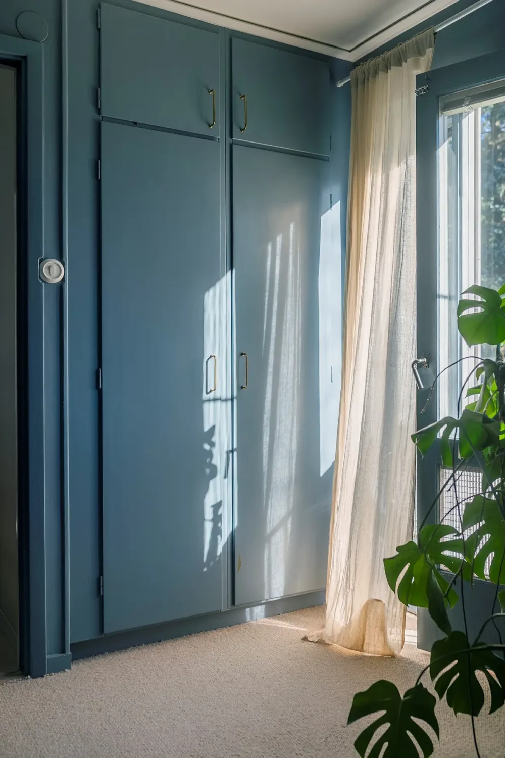 A Charming 1960s Family Home in Stockholm 26 blue bedroom built-in wardrobes