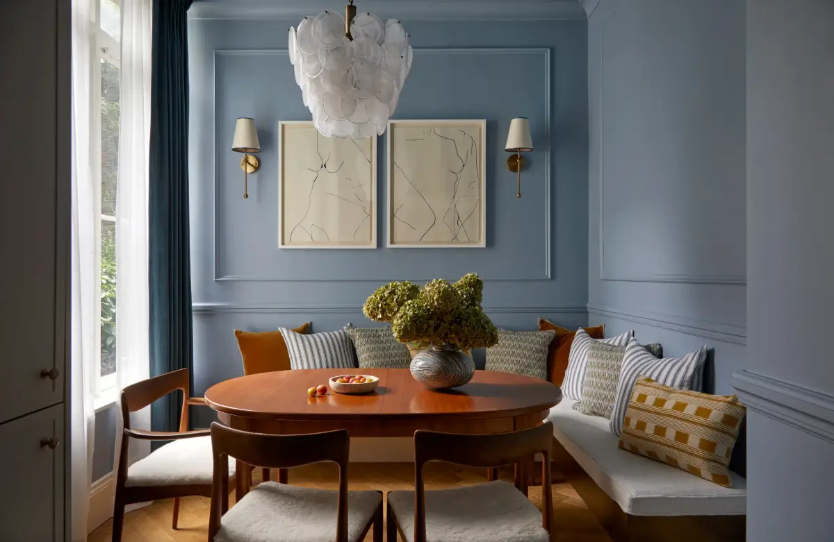 A Notting Hill Duplex Pairs Art and Victorian Architecture 9 blue-dining-room-built-in-corner-bench