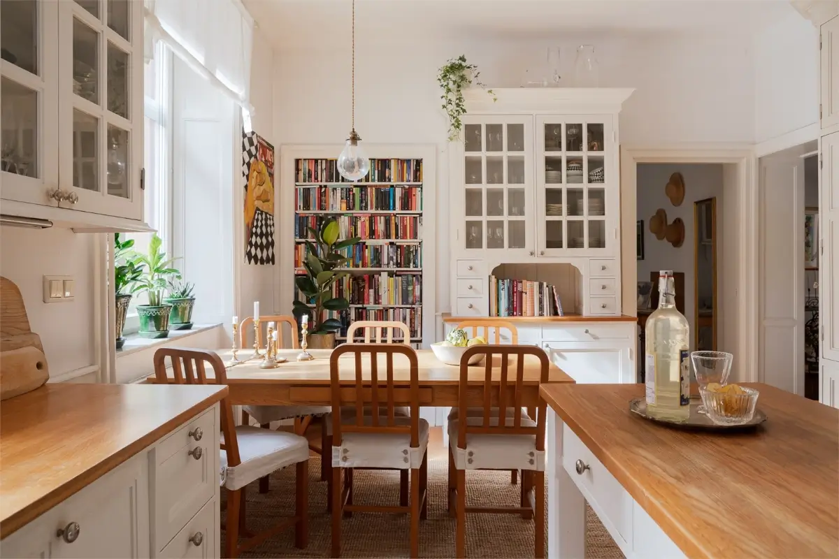 A Light-Filled Stockholm Apartment with a Charming Kitchen 4 classic kitchen with dining table and built-in bookshelves