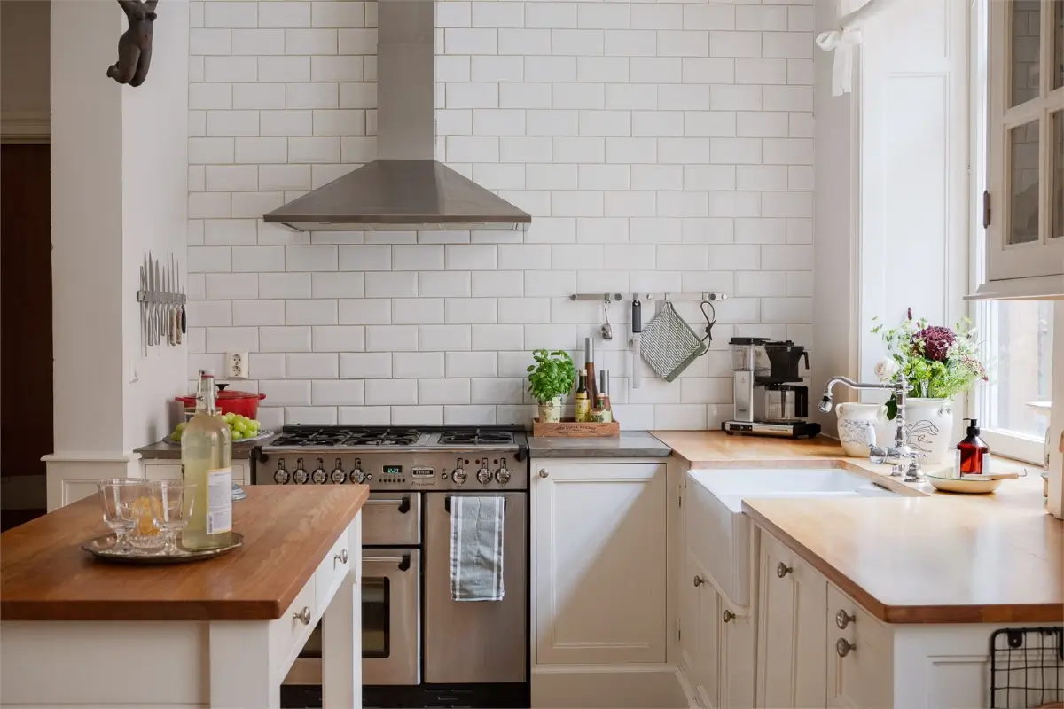 A Light-Filled Stockholm Apartment with a Charming Kitchen 2 classic white kitchen subway tiles