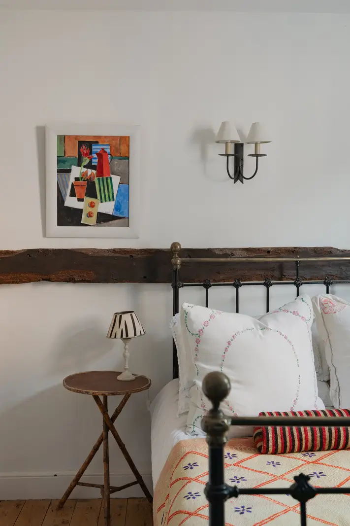 A Charming English Cottage with a Sage-Green Kitchen 17 cottage bedroom timber beam