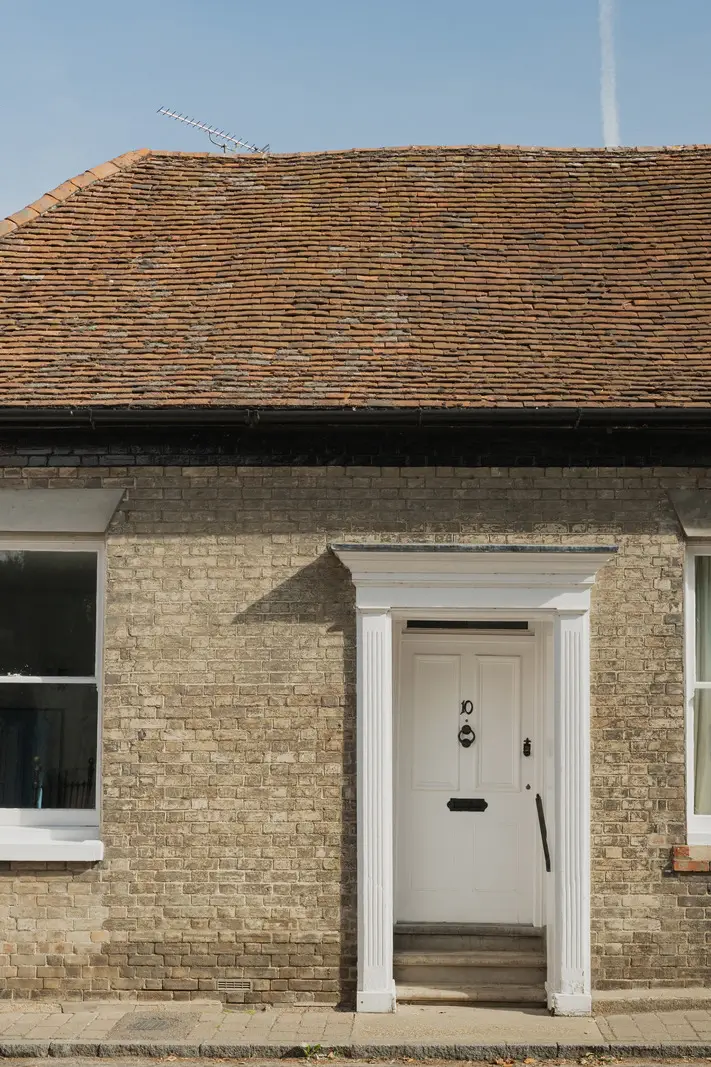 A Charming English Cottage with a Sage-Green Kitchen 25 cottage front door