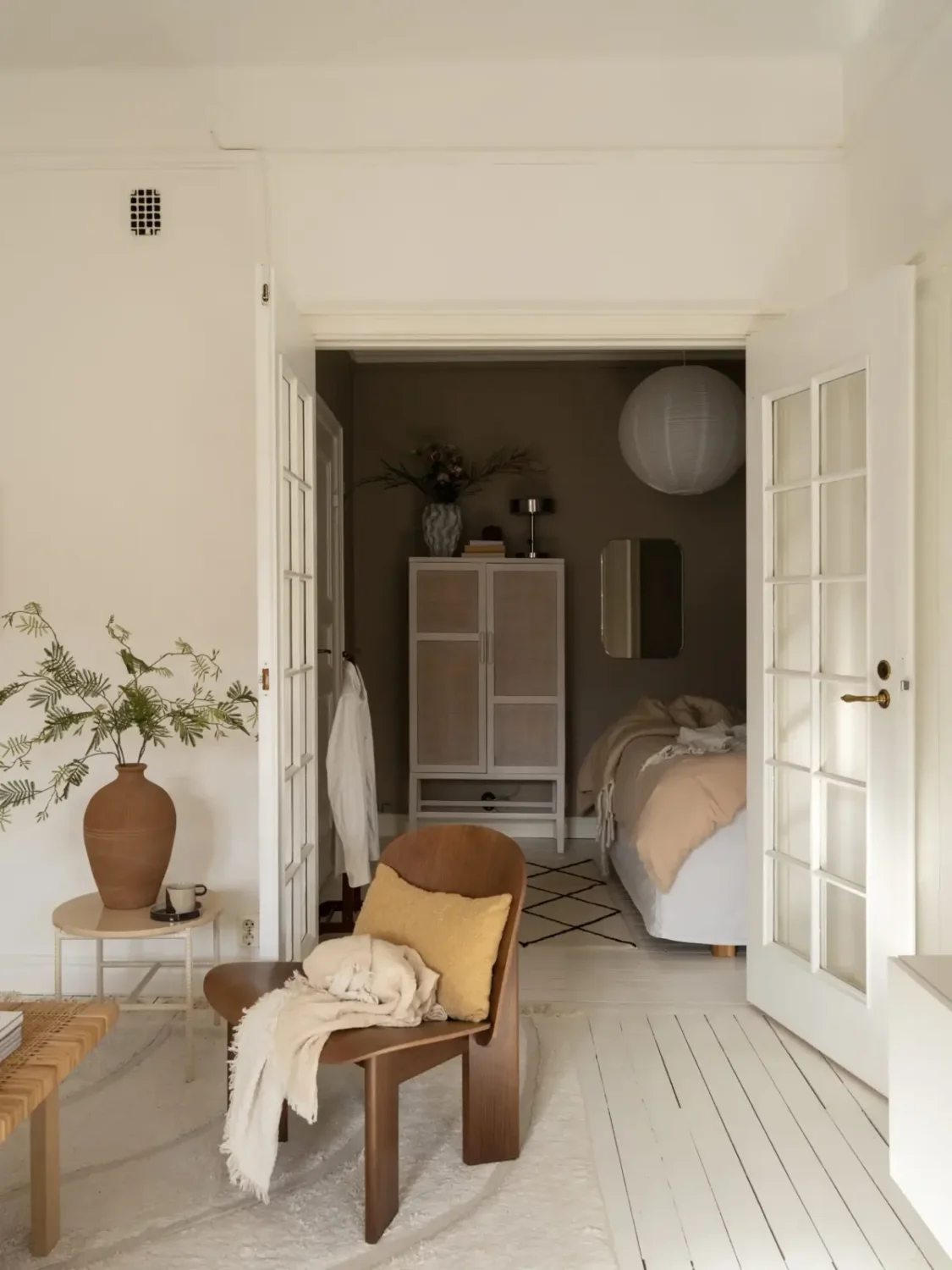 A Fresh 1920s Apartment with White Floorboards and Exposed Brick 15 double glass doors bedroom