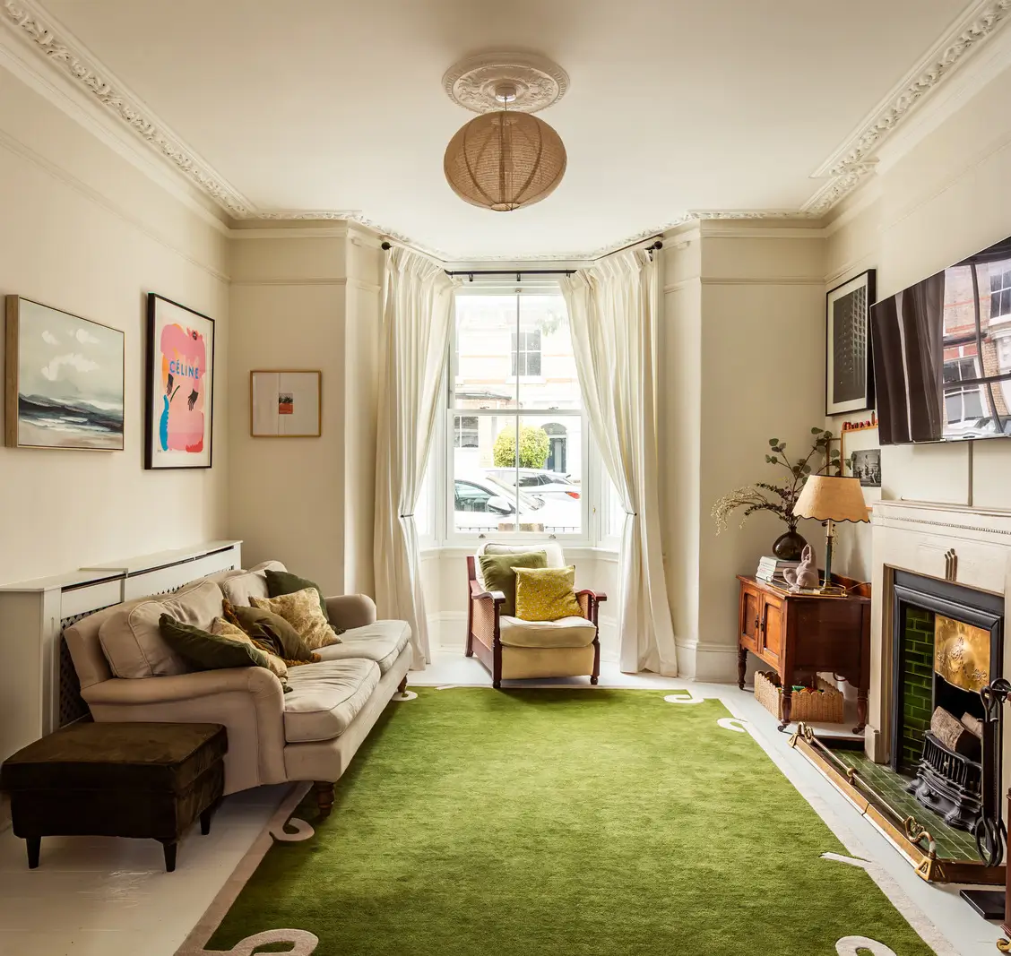 Period Elements and Subtle Color Accents in a Victorian Family Home 1 front living room bay window fireplace green rug