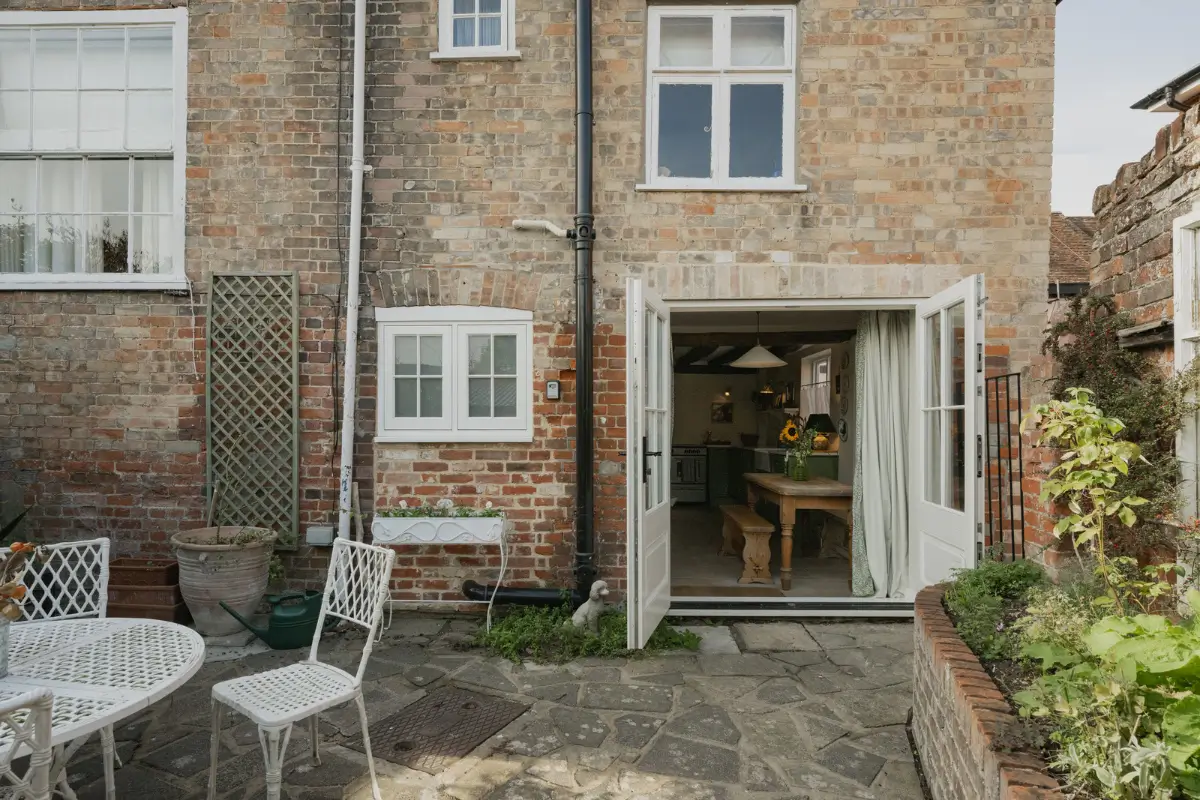 A Charming English Cottage with a Sage-Green Kitchen 23 garden kitchen doors