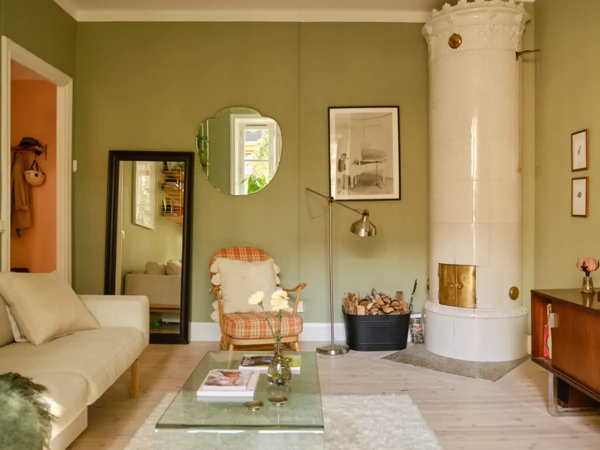 Green and Apricot Rooms in a Charming Stockholm Apartment 10 green living room fireplace