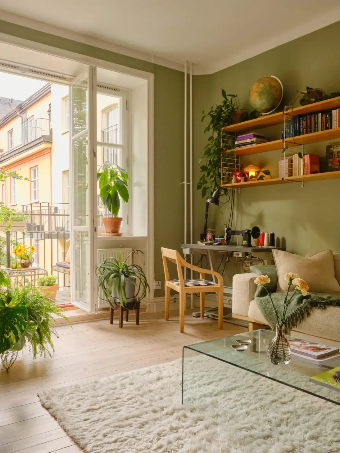Green and Apricot Rooms in a Charming Stockholm Apartment 2 green living room glass balcony doors