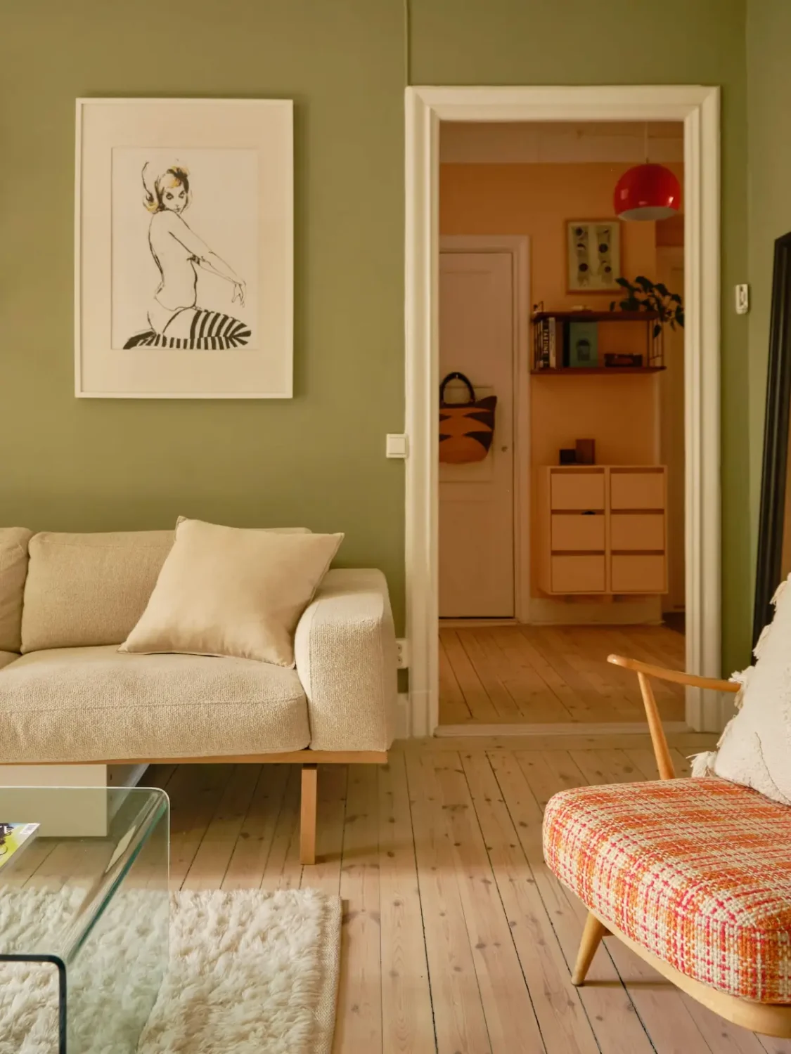 Green and Apricot Rooms in a Charming Stockholm Apartment 12 green living room wooden floor