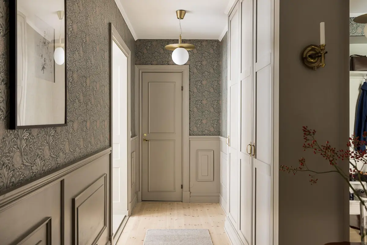 Gray Tones, Wallpapers, and a Mint Green Fireplace in a Swedish Apartment 34 hall built-in storage william morris wallpaper