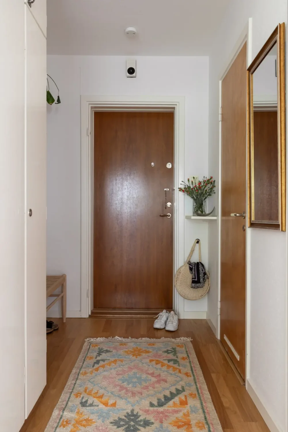 A Well-Preserved 1950s Apartment North of Stockholm 26 hall built-in wardrobes colorful rug