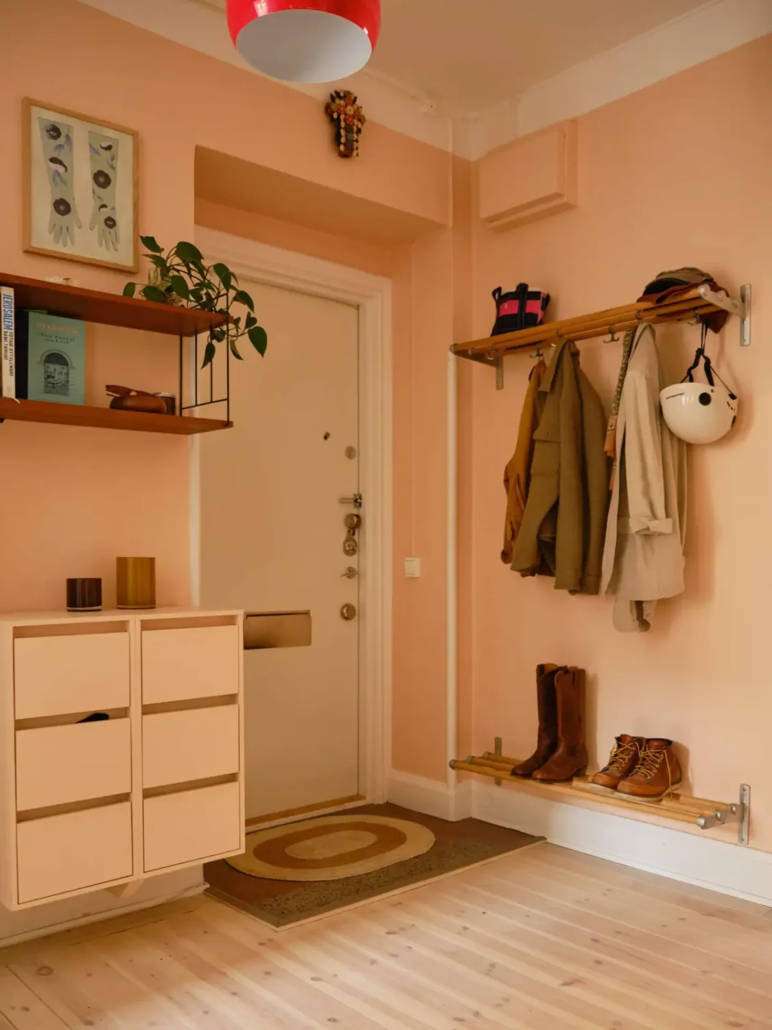 Green and Apricot Rooms in a Charming Stockholm Apartment 27 hall storage cabinets apricot colored walls nordroom Green and Apricot Rooms in a Charming Stockholm Apartment