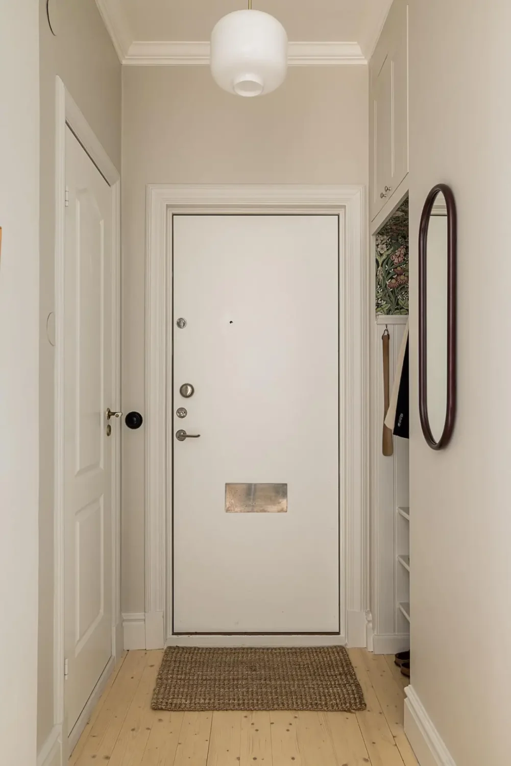 A Classic Renovated Apartment with a Social Light Green Kitchen 36 hall with wallpapered storage niche