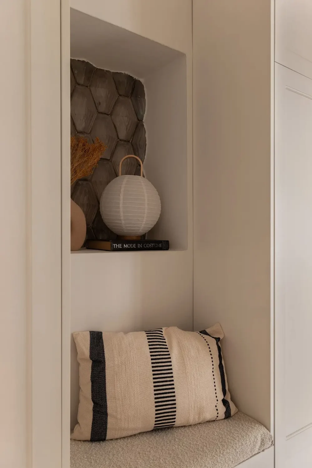Neutral Tones and Period Character from the 1910s in a Stockholm Apartment 27 hallway bench