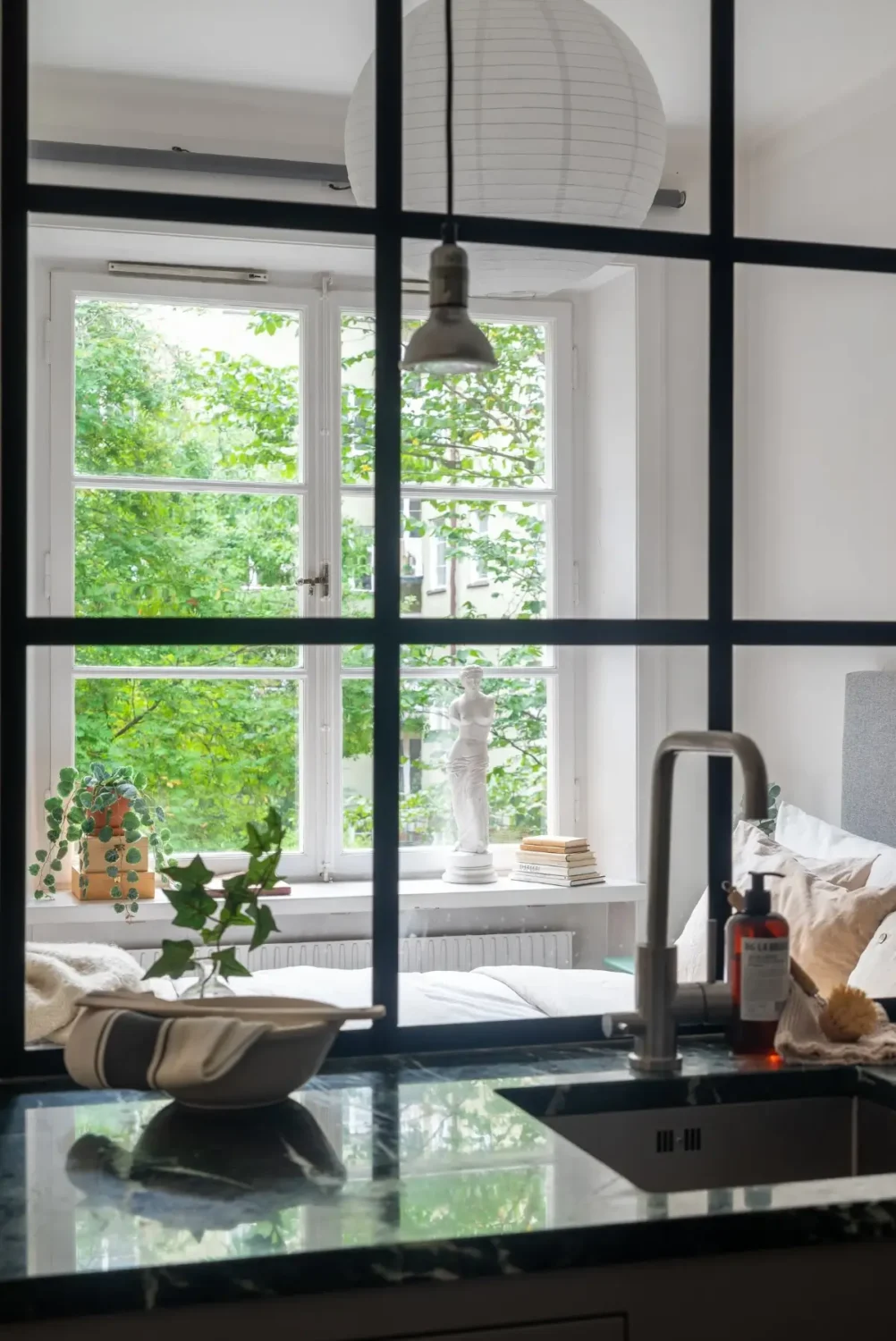 A Gray Kitchen with a Green Marble Countertop in a Small Apartment 18 industrial window