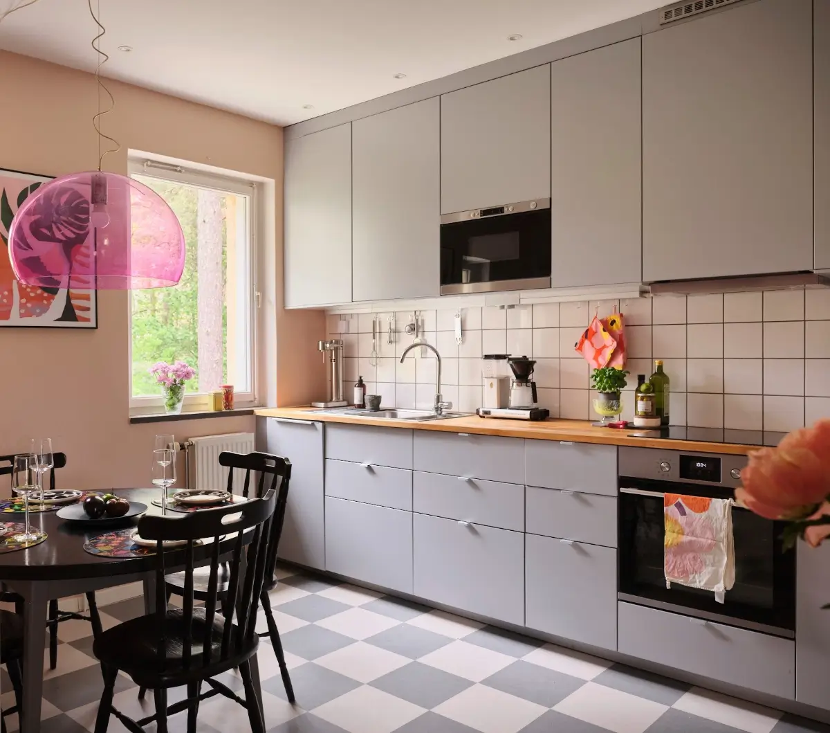 A Natural Color Palette in a Swedish 1940s Apartment 13 kitchen gray cabinets checkered floor round black table