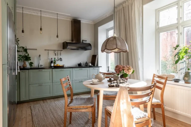 kitchen green cabinets round wooden table