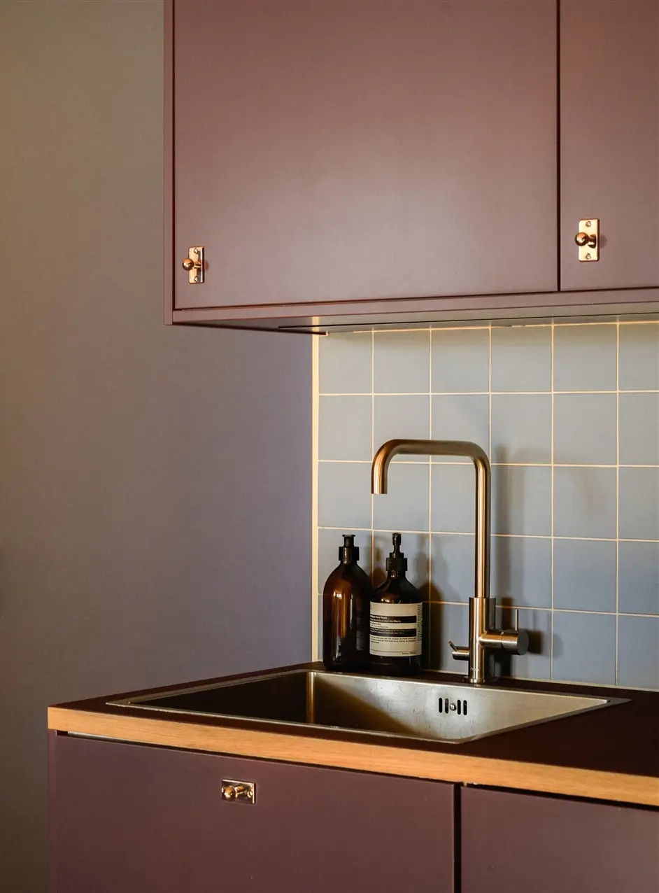 A Colorful Stockholm Family Apartment with Views of the Lake 14 kitchen sink blue backsplash tiles