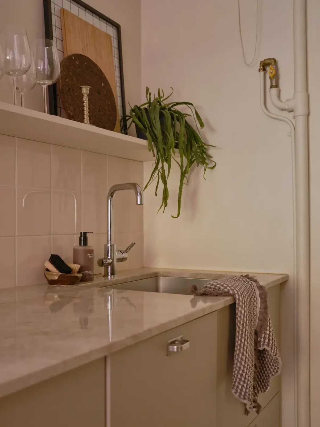 A Light 1930s Apartment with a Bubblegum Pink Bedroom 17 kitchen sink with shelf