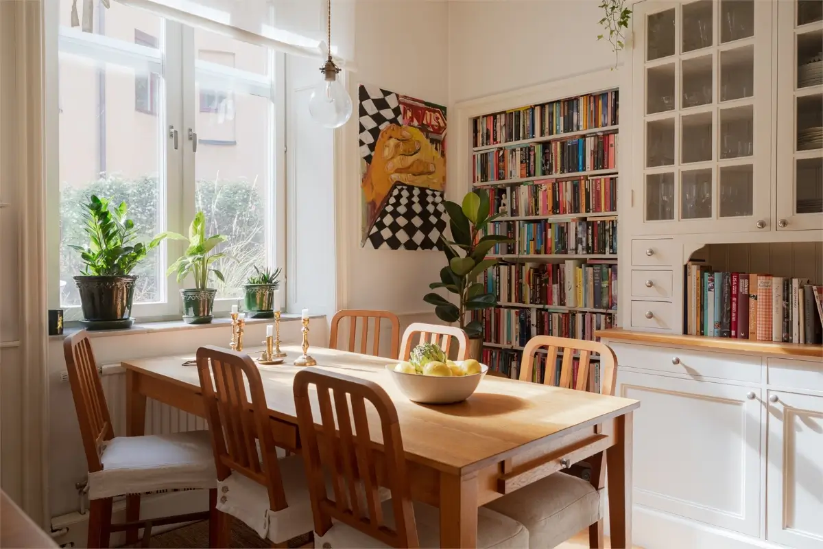 A Light-Filled Stockholm Apartment with a Charming Kitchen 5 kitchen table built-in bookshelves