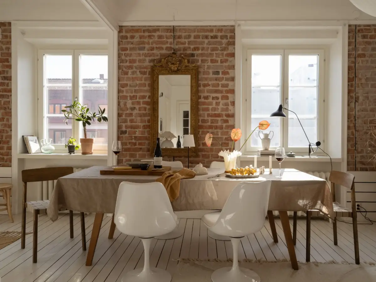 A Fresh 1920s Apartment with White Floorboards and Exposed Brick 5 large dining table brick wall
