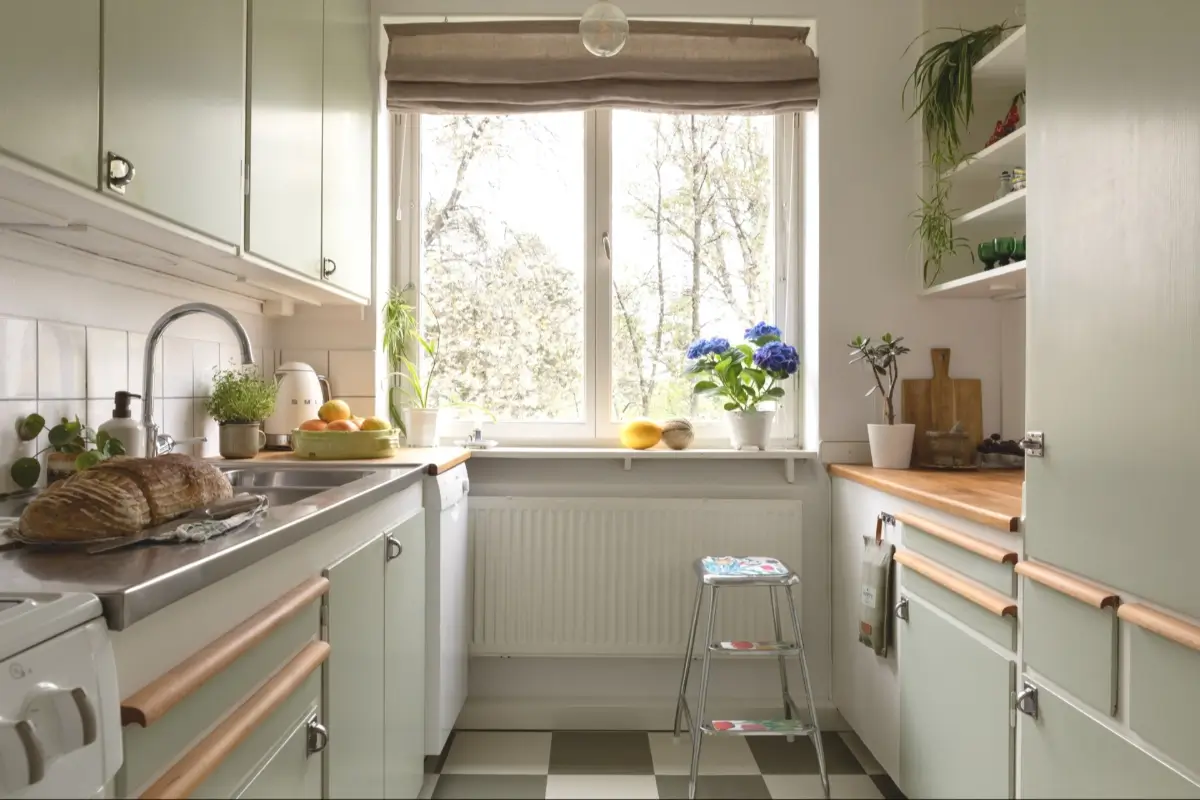 A Well-Preserved 1950s Apartment North of Stockholm 12 light green midcentury kitchen opening with shelves