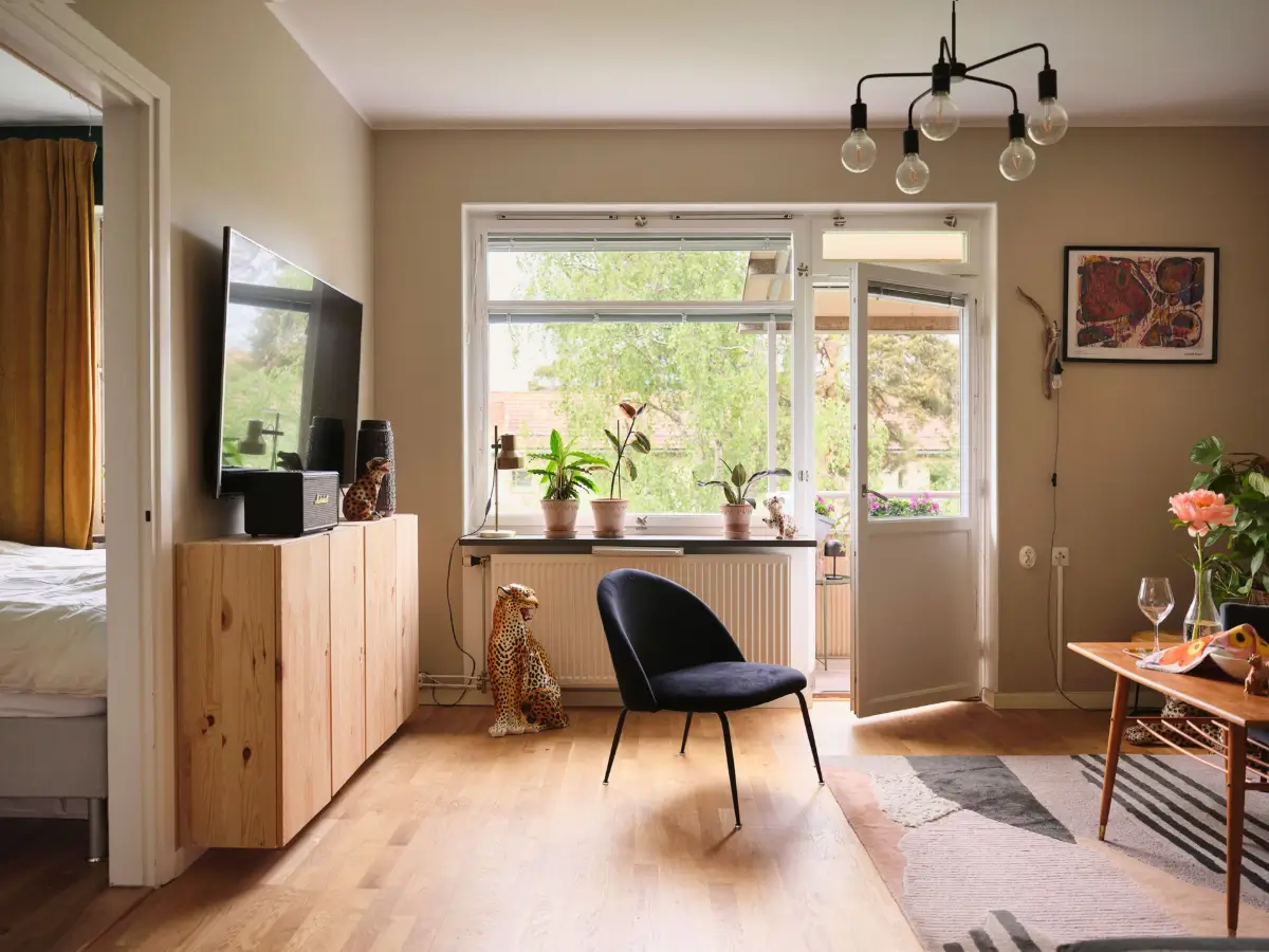 A Natural Color Palette in a Swedish 1940s Apartment 3 living room colorful rug large window