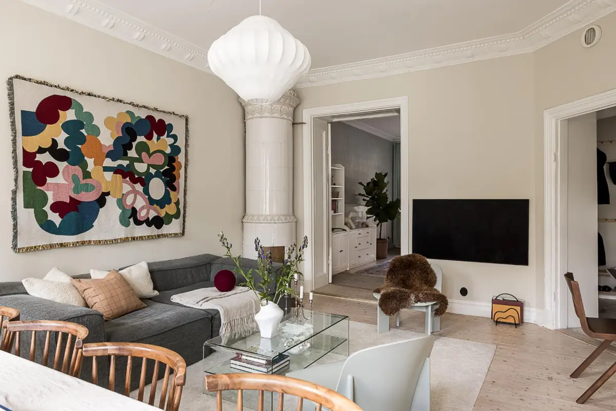 Warm Neutral Tones and Period Features in a Swedish Apartment 4 living room fireplace