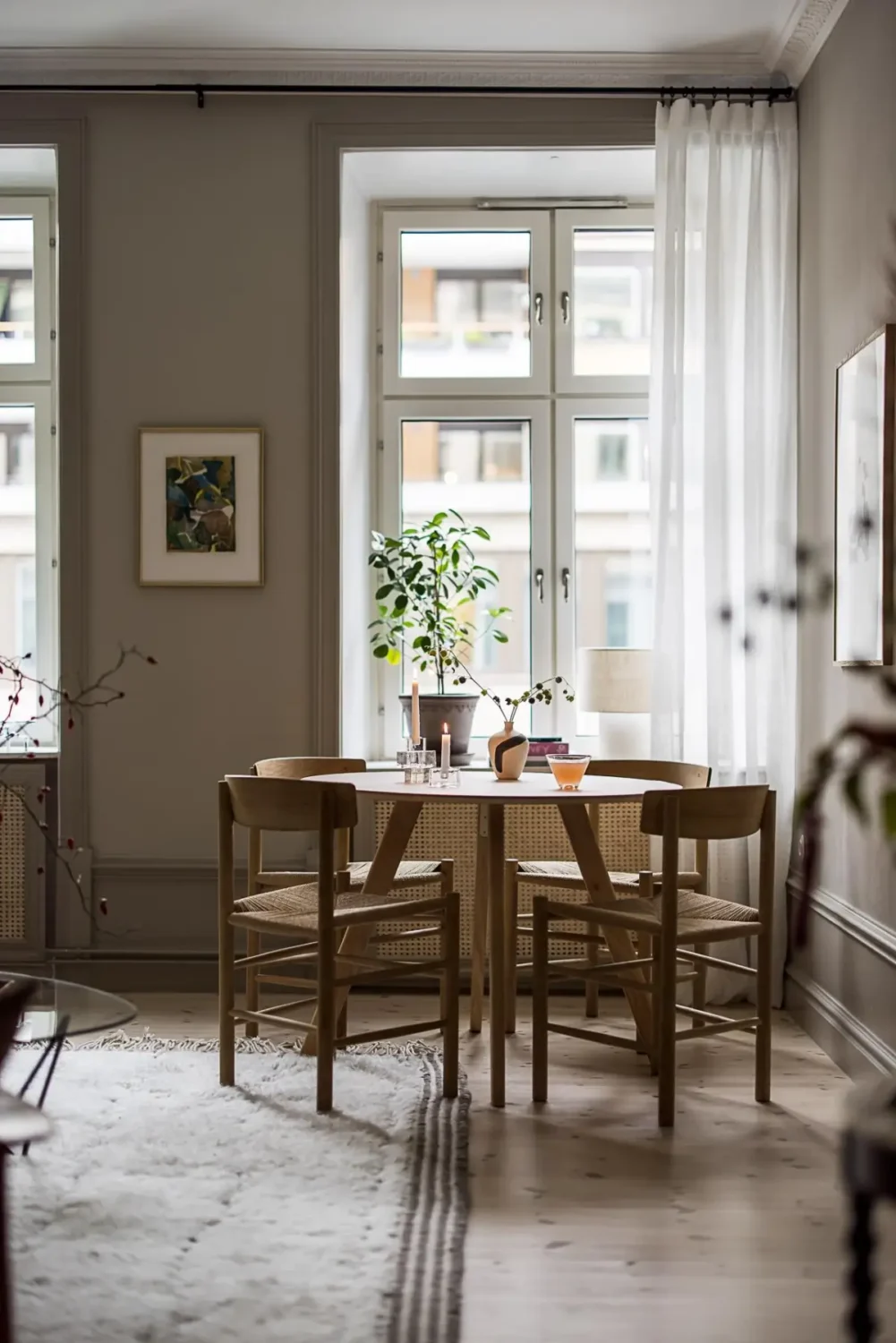 Gray Tones, Wallpapers, and a Mint Green Fireplace in a Swedish Apartment 6 living room large windows round table