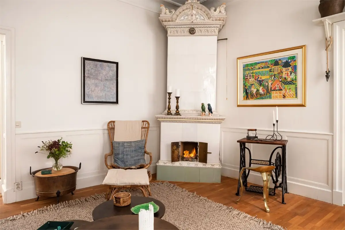 A Light-Filled Stockholm Apartment with a Charming Kitchen 13 living room ornate fireplace