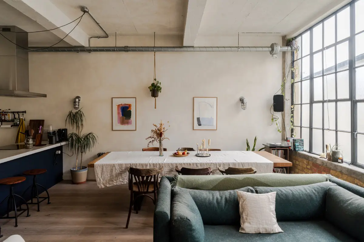An Industrial London Apartment in a Former 1920s Shoe Factory 3 living room plaster walls large dining table