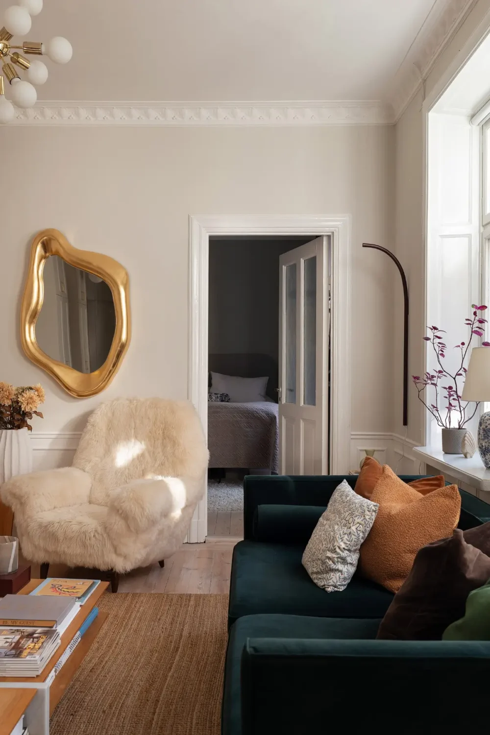 Neutral Tones and Period Character from the 1910s in a Stockholm Apartment 4 living room velvet green sofa jute rug
