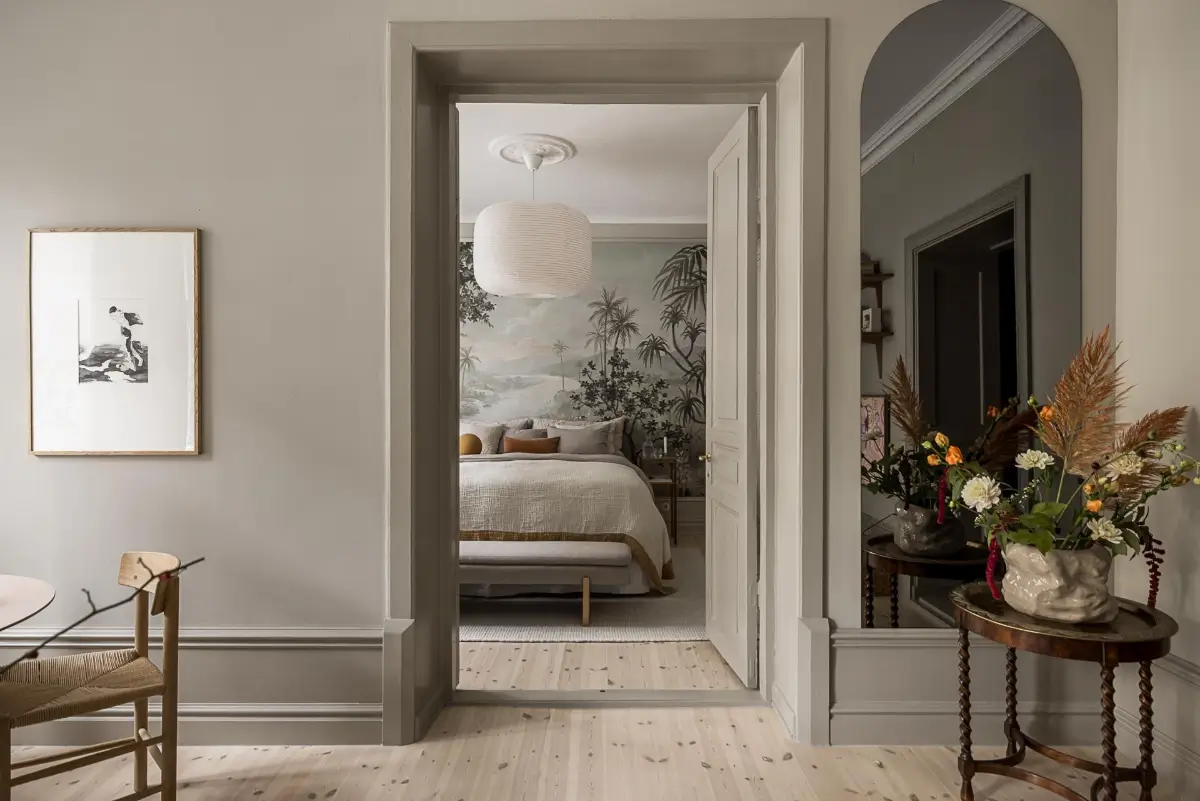 Gray Tones, Wallpapers, and a Mint Green Fireplace in a Swedish Apartment 13 living room view into bedroom