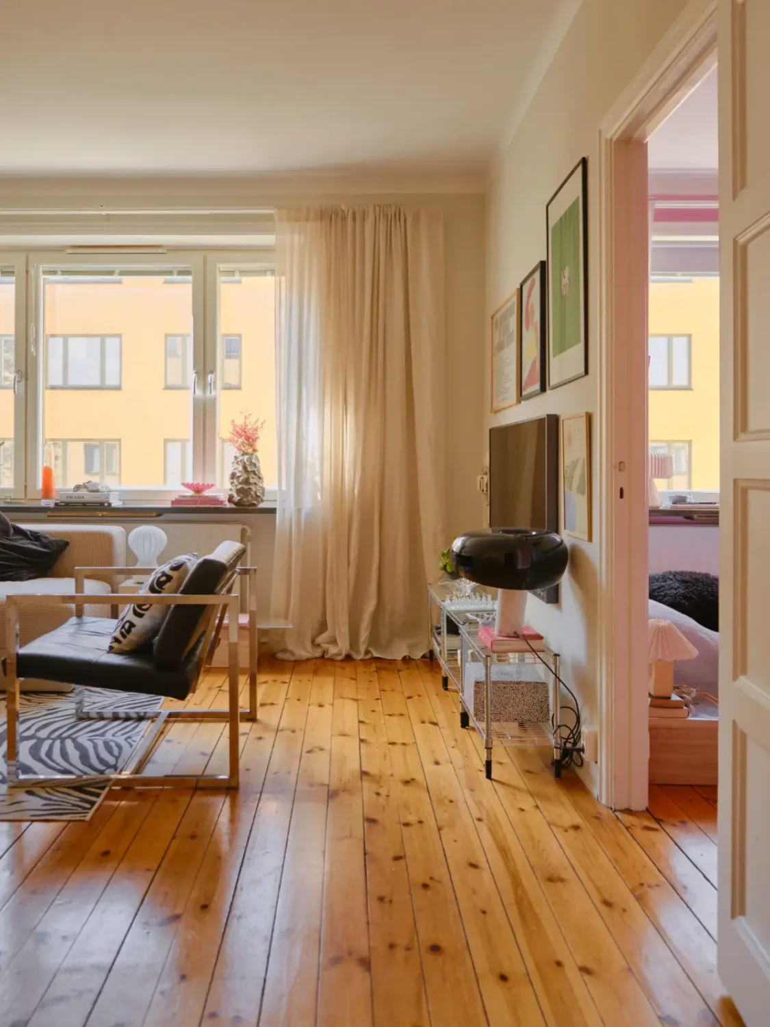 A Light 1930s Apartment with a Bubblegum Pink Bedroom 11 living room warm wooden floorboards