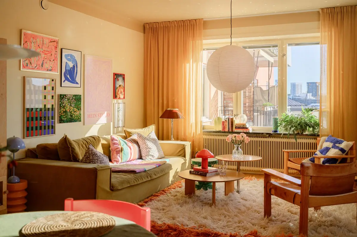 A Colorful Stockholm Family Apartment with Views of the Lake 5 living room yellow walls green sofa large rug nordroom