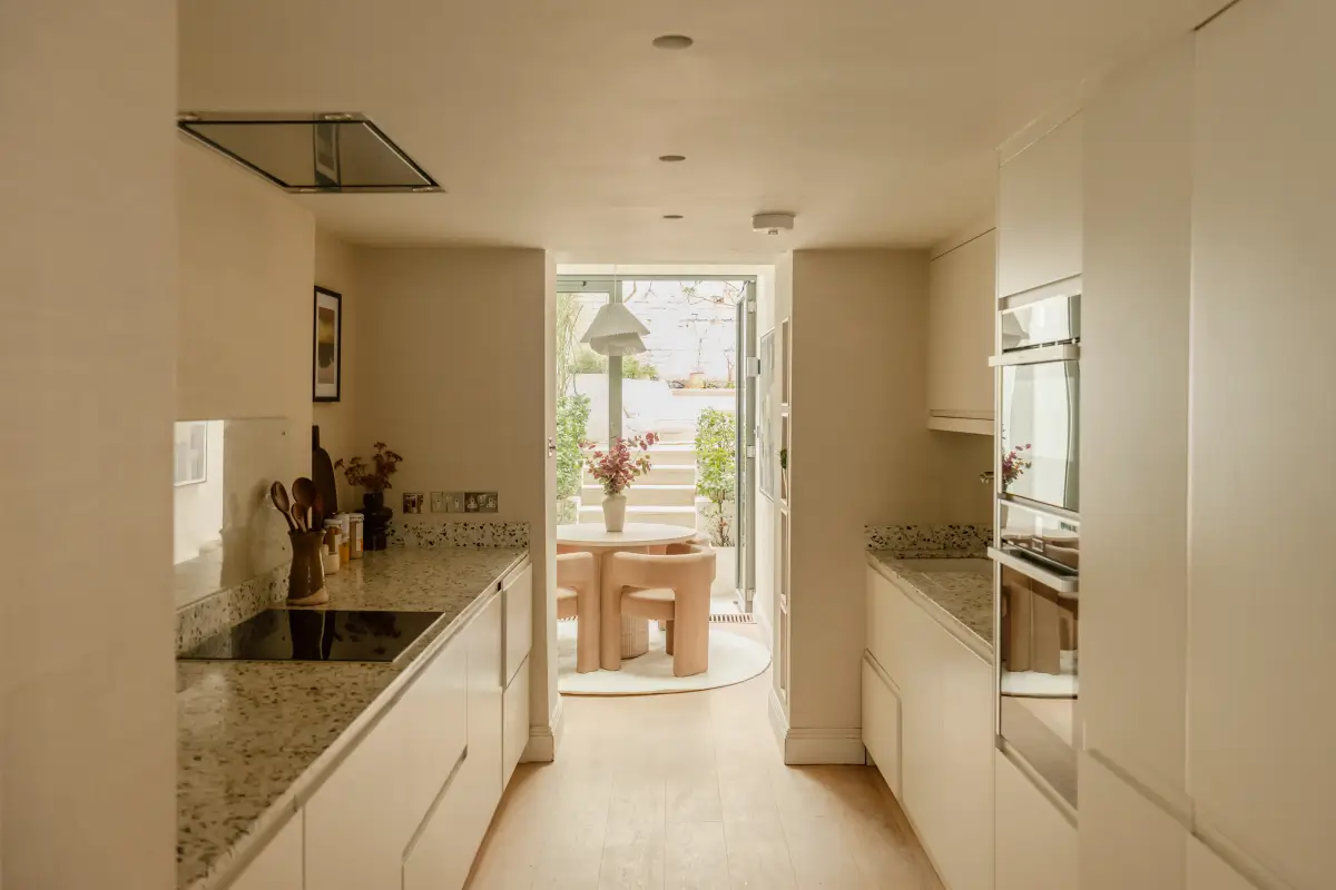 A Serene Duplex Apartment with a Glass Extension in London 7 modern white galley kitchen cabinets