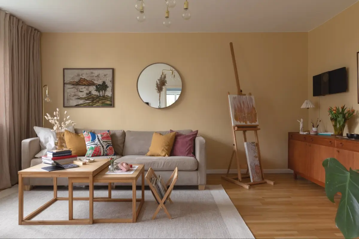 A Well-Preserved 1950s Apartment North of Stockholm 4 ochre walls living room gray sofa