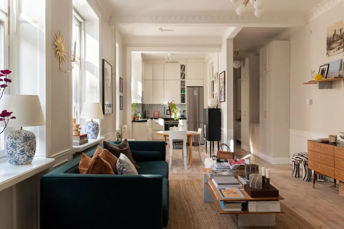 Neutral Tones and Period Character from the 1910s in a Stockholm Apartment 8 open plan living room jute rug velvet sofa