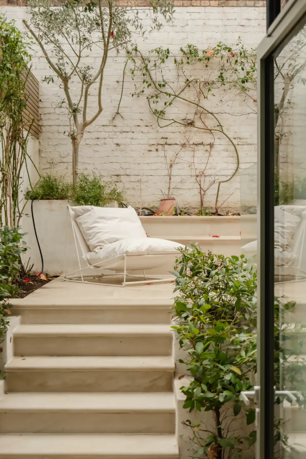 A Serene Duplex Apartment with a Glass Extension in London 13 raised walled garden